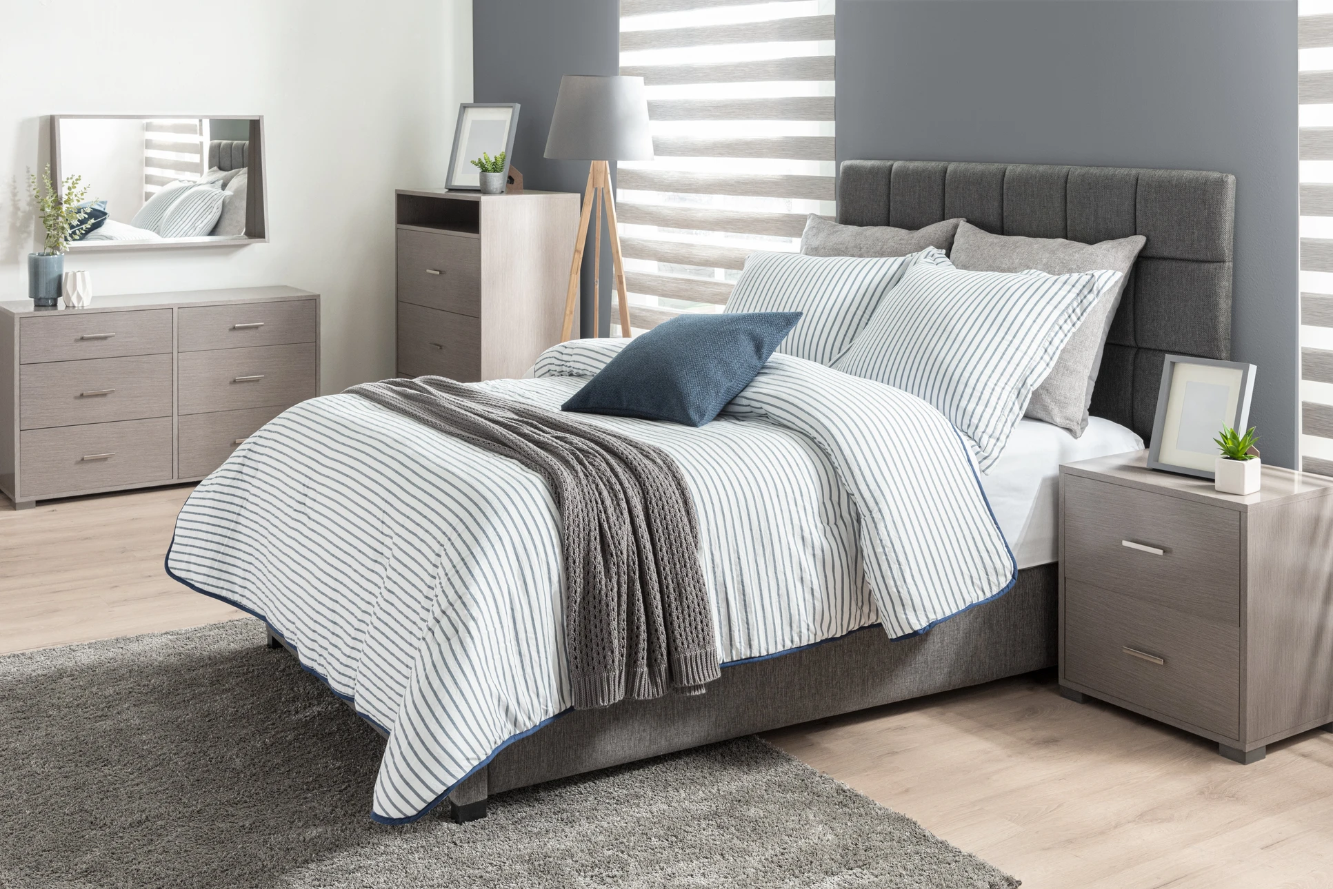 Chambre moderne avec lit double en bois clair, tête de lit géométrique en panneaux de bois